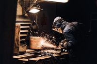 man-protective-mask-is-cutting-metal-sparks-are-flying-away